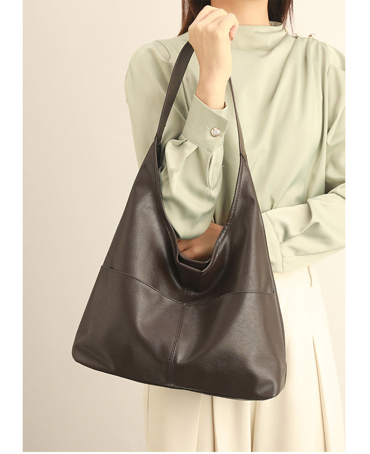 Oversized slouchy hobo tote bag in dark brown smooth matte leather-look finish with long flat shoulder strap and panelled