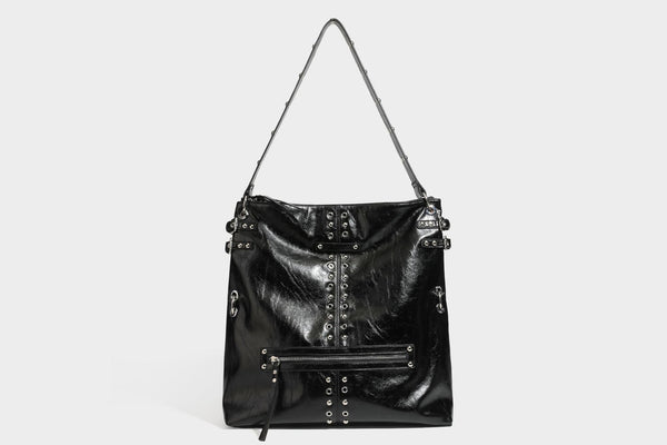 Black glossy leather-look slouchy shoulder bag with silver stud and eyelet hardware, top zip closure, front zip pocket, and