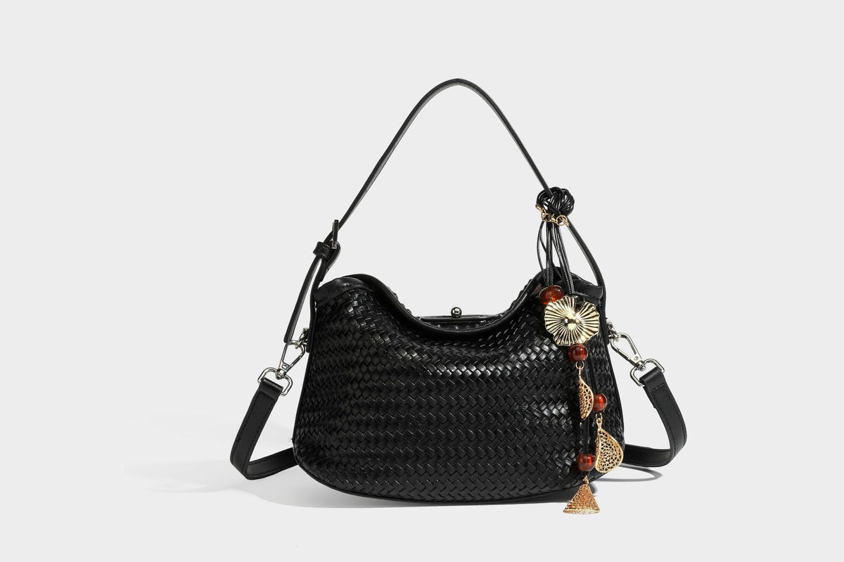 Small woven-look leather-look flap shoulder hobo bag in burgundy with silver-tone hardware and decorative tassel charm