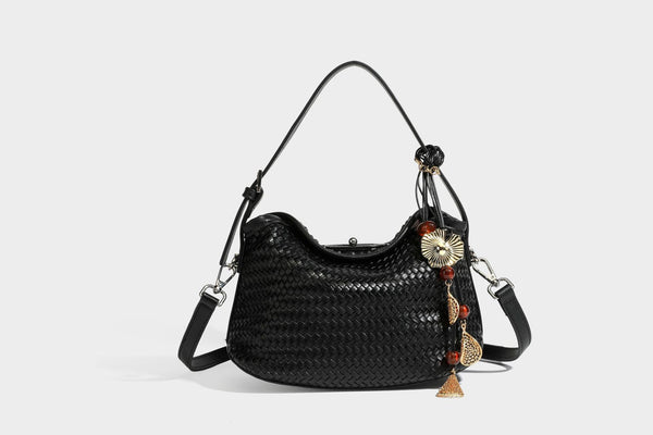 Small woven-look leather-look flap shoulder hobo bag in burgundy with silver-tone hardware and decorative tassel charm
