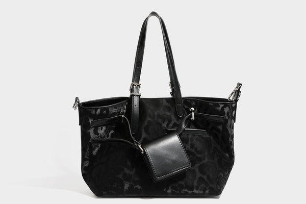 Glossy leopard-print tote bag with leather-look dark trim, dual top handles, detachable shoulder strap, and attached front