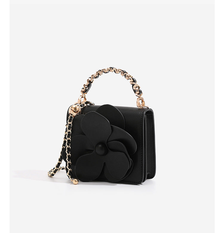 Small structured rectangular crossbody bag with layered 3D flower appliqué and gold-tone chain strap, detail view 12
