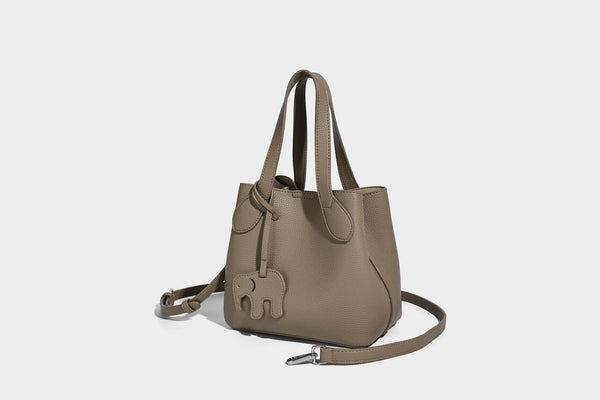 Compact pebbled bucket tote bag with elephant charm, twin top handles, and detachable crossbody strap, detail view 22
