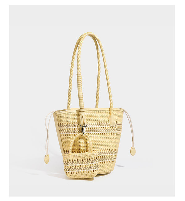 Structured woven bucket tote bag in pastel blue with braided shoulder strap, open lattice weave body, cream drawstring