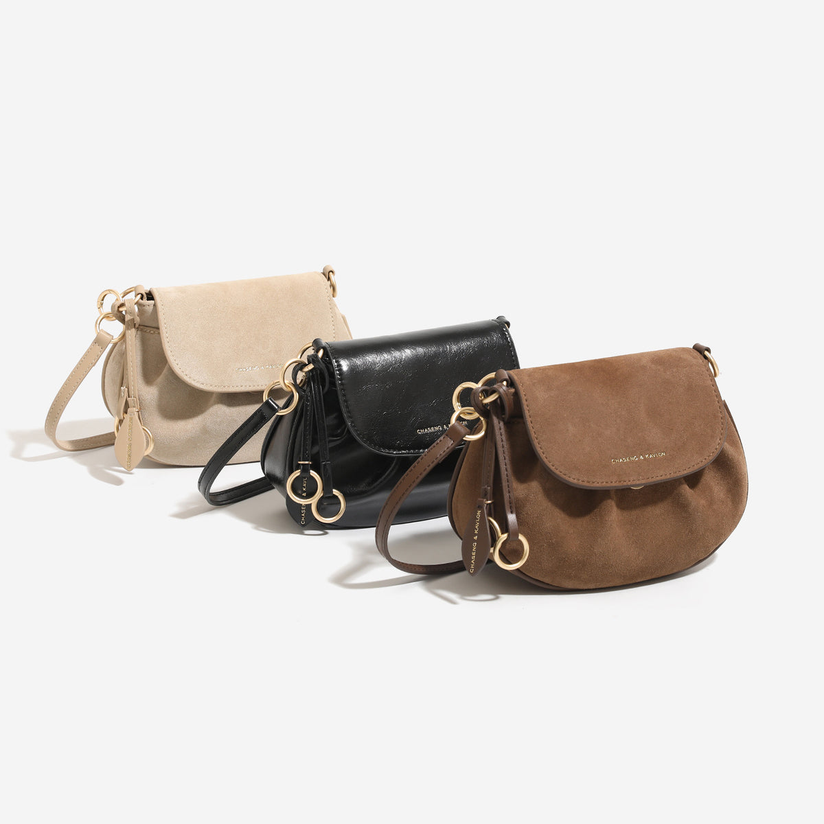 Small flap saddle crossbody bag with gold-tone ring hardware and adjustable strap, front view