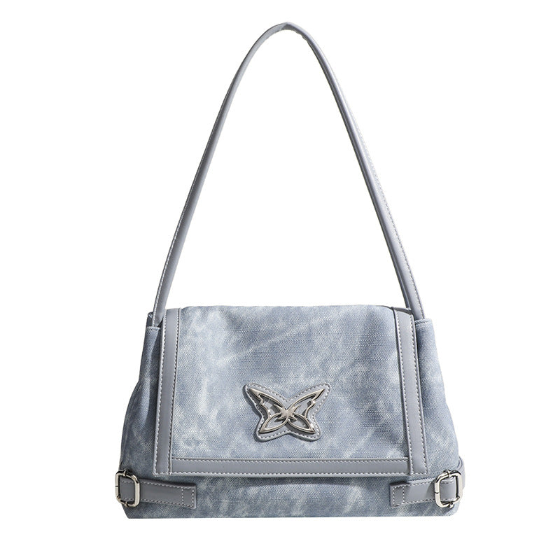 Washed leather-look shoulder tote bag with silver butterfly emblem and buckle hardware, detail view 5