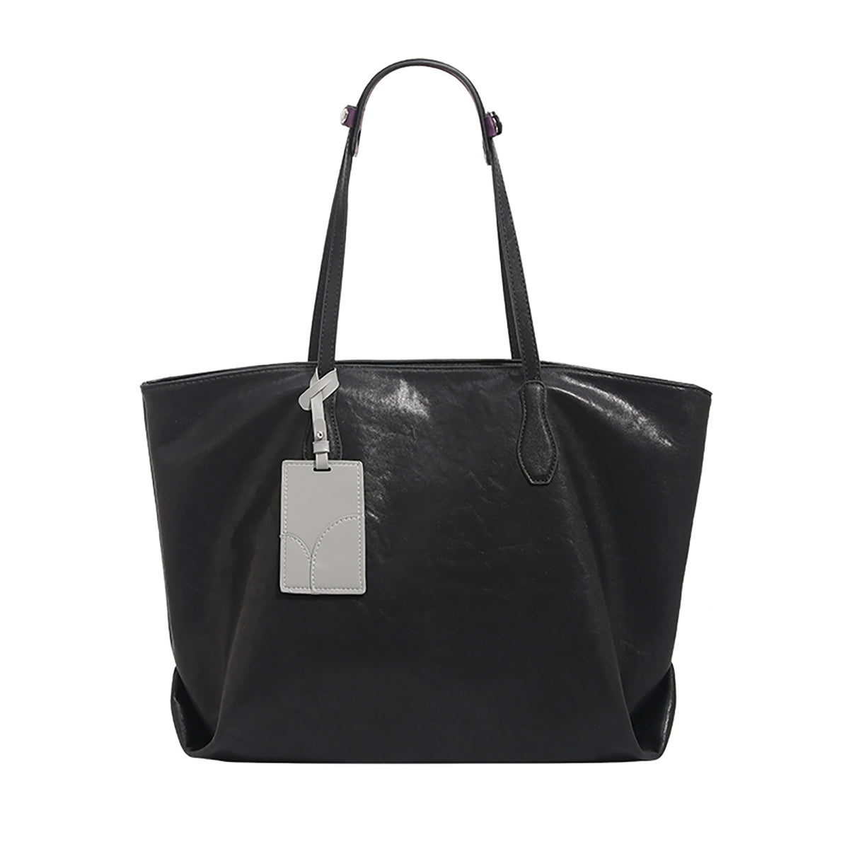 Oversized slouchy leather-look tote bag with long shoulder straps, contrast grey hanging tag, and silver-tone hardware