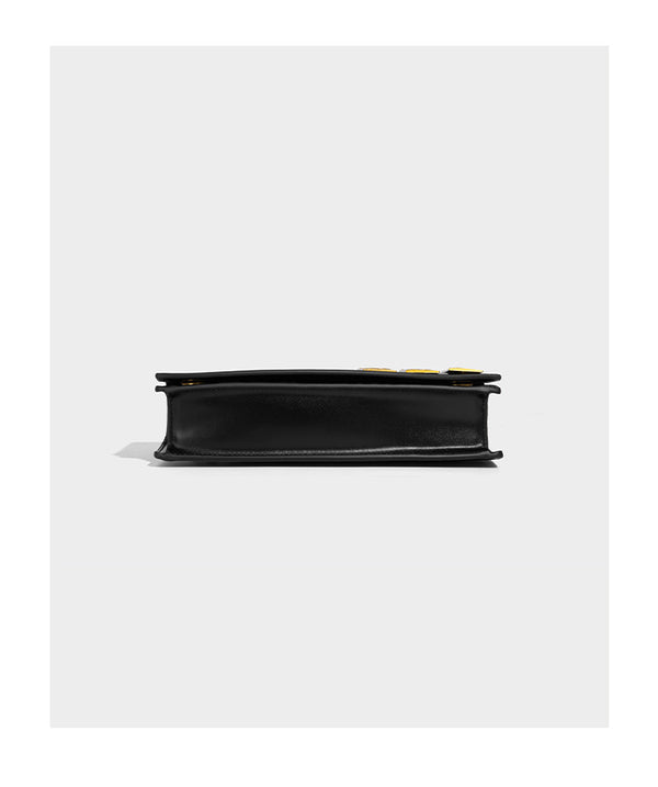 Structured rectangular crossbody bag with glossy finish, three vertical gold-tone embossed plaques, and gold chain strap