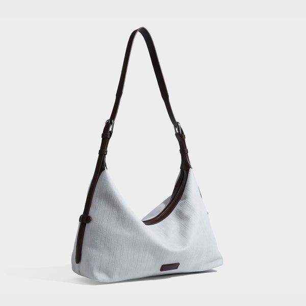 Slouchy olive green canvas hobo shoulder bag with black leather-look trim, zip-top closure, and adjustable strap, front view