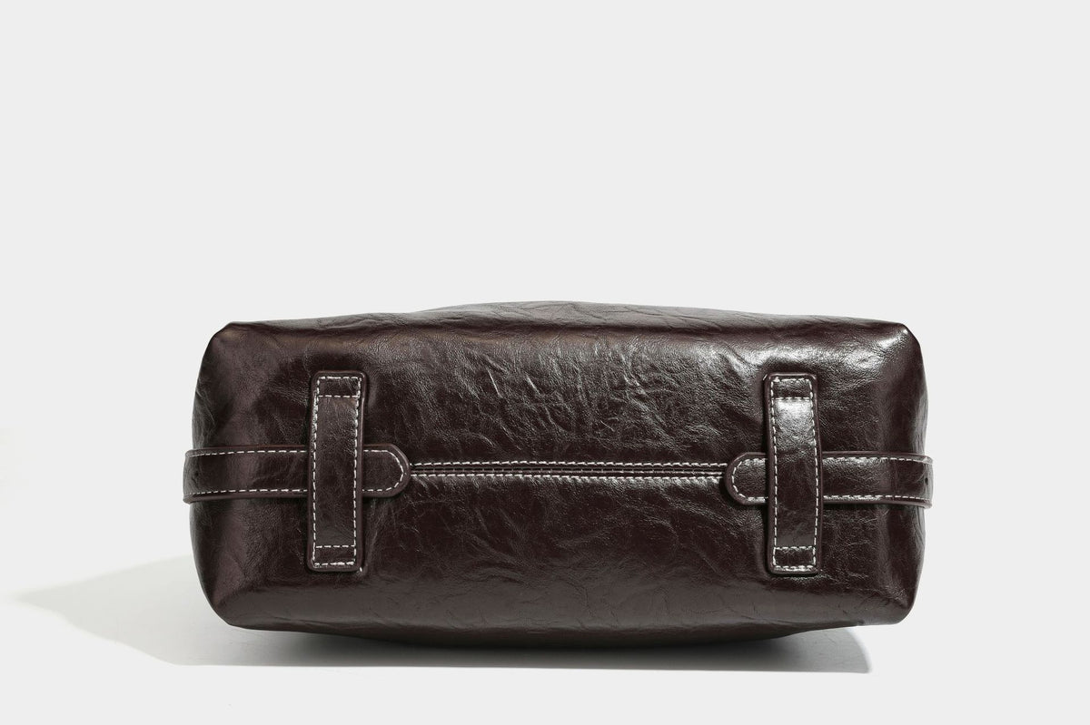 Slouchy hobo shoulder bag in glossy crinkled leather-look finish with zip-top closure and silver-tone ring hardware, detail