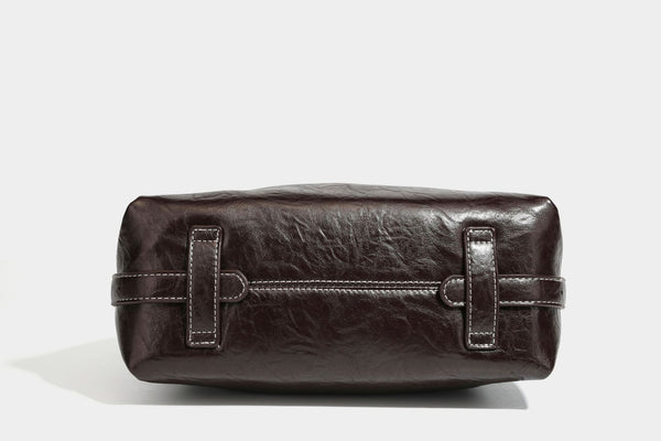 Slouchy hobo shoulder bag in glossy crinkled leather-look finish with zip-top closure and silver-tone ring hardware, detail