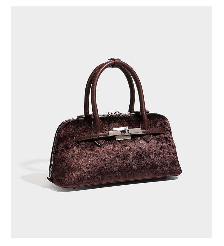 Small structured satchel bag in dark brown velvet-like textured finish with leather-look trim, silver-tone turn-lock bar