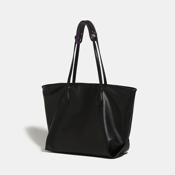 Large black leather-look trapezoid tote bag with double shoulder straps and purple accent hardware, detail view 2