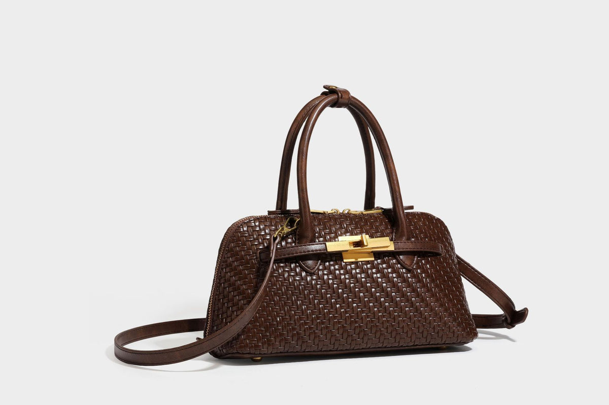 Structured woven-embossed leather-look satchel with dual rolled top handles, gold-tone turn-lock closure, and detachable