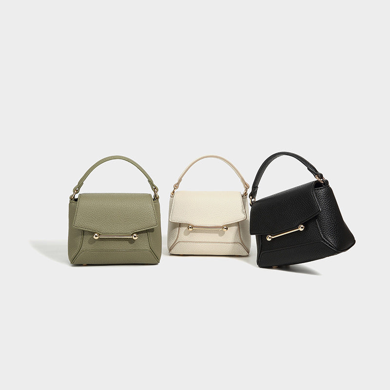 Small structured pebbled flap mini satchel with gold-tone bar hardware, short top handle, and detachable crossbody strap