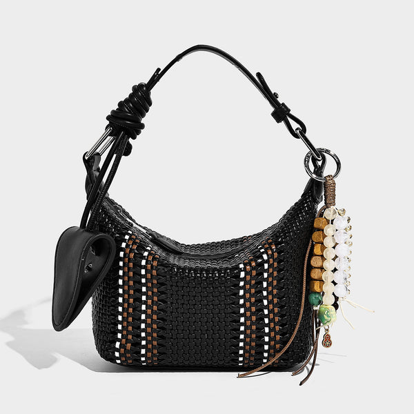 Small woven crescent shoulder bag with leather-look trim, zip closure, silver-tone ring hardware, and beaded tassel charm