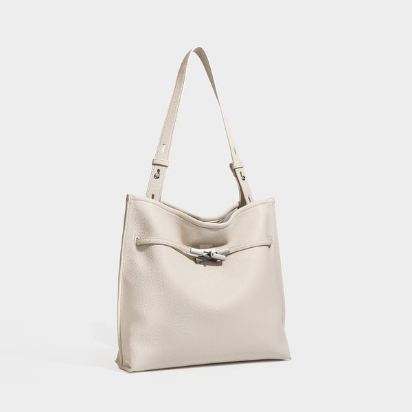 Large structured tote bag in pebbled leather-look finish with silver-tone twist-knot front detail and adjustable shoulder