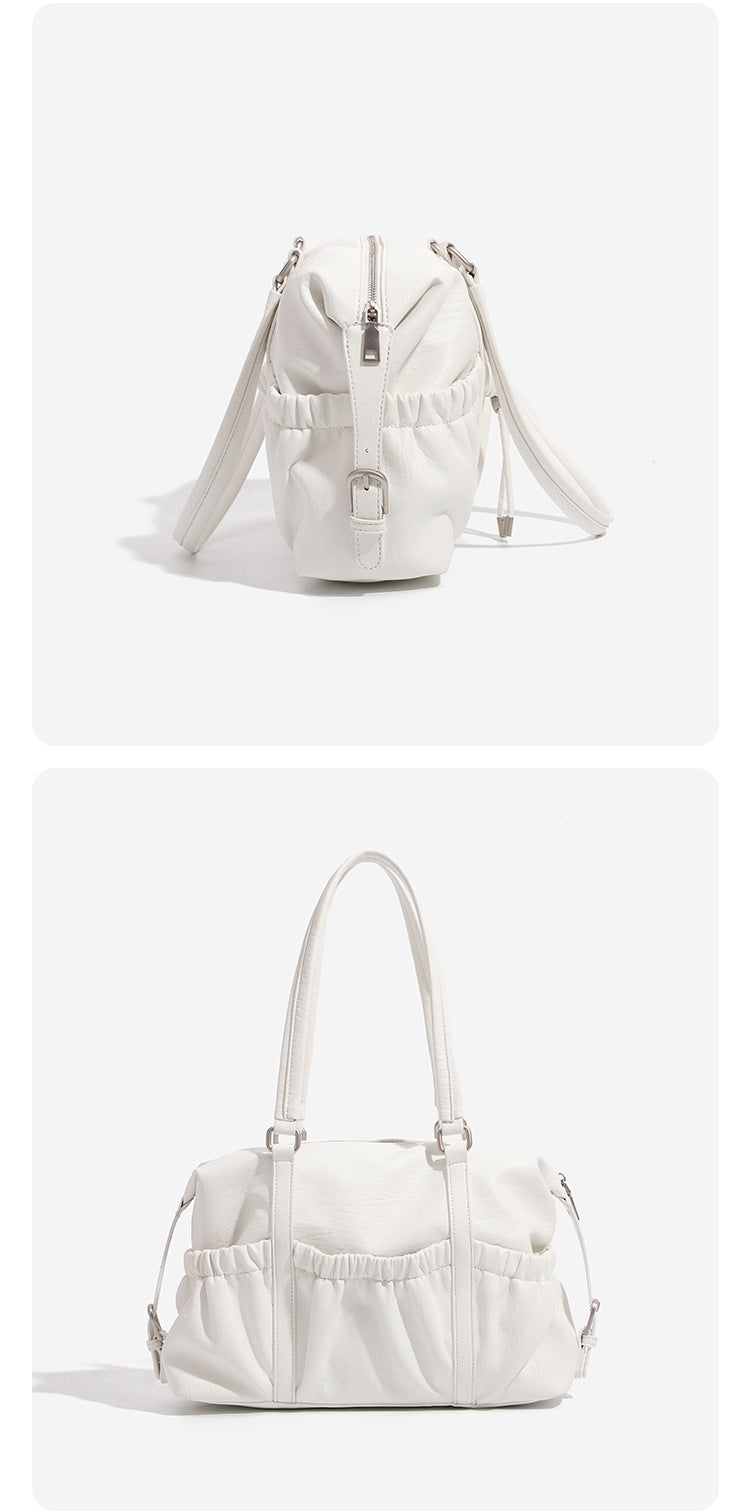 Ivory leather-look shoulder bag with ruched front panels, drawstring toggle, silver-tone hardware, and dual top handles