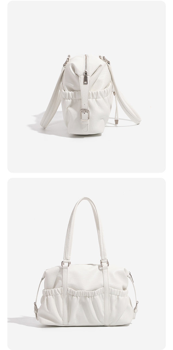 Ivory leather-look shoulder bag with ruched front panels, drawstring toggle, silver-tone hardware, and dual top handles