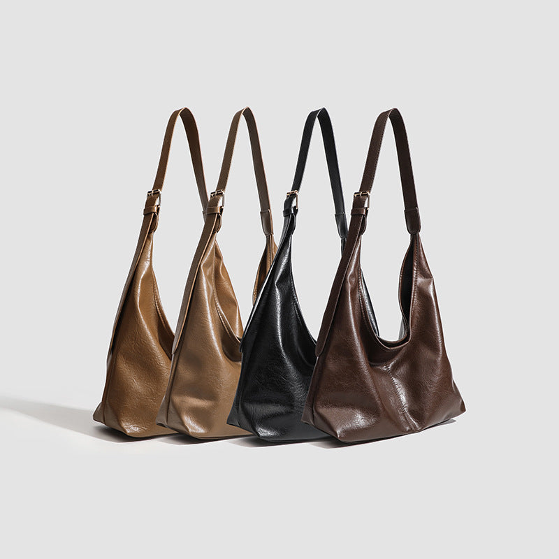 Large slouchy hobo shoulder bag in smooth leather-look finish with adjustable strap and gold-tone hardware, detail view 2