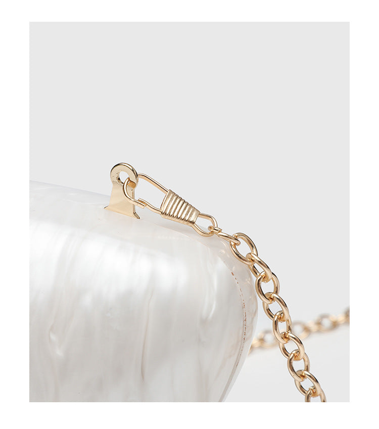 Oval hard-shell marbled gloss clutch bag with gold-tone kiss-lock clasp and detachable gold chain strap, detail view 15