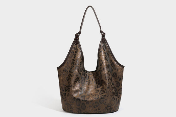 Large slouchy leopard-print shoulder tote bag with glossy tan-and-brown finish, dark brown leather-look trim, single