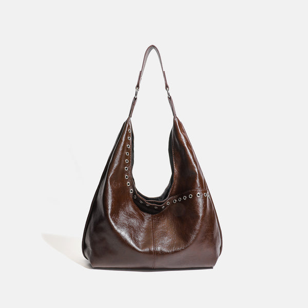 Large slouchy hobo shoulder bag with silver eyelet trim and glossy leather-look finish, detail view 7