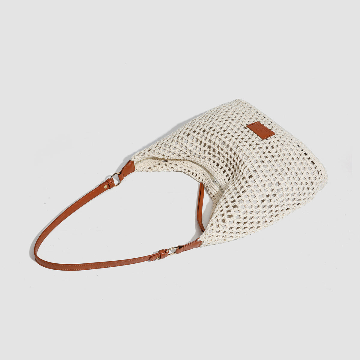 Cream open-weave crochet hobo shoulder bag with tan leather-look strap and gold-tone ring hardware, detail view 4