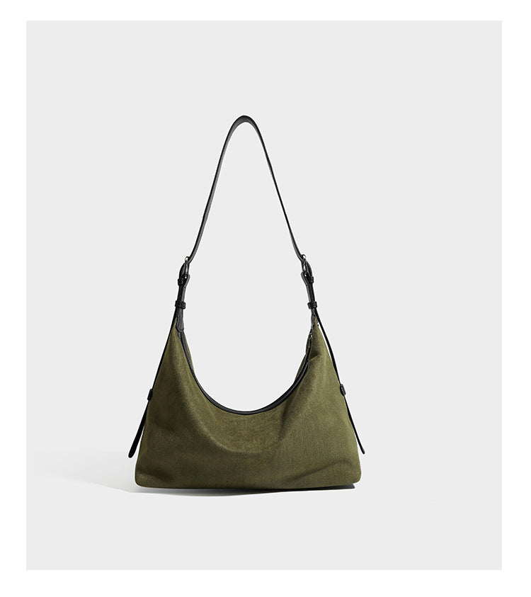 Slouchy olive green canvas hobo shoulder bag with black leather-look trim, zip-top closure, and adjustable strap, detail view