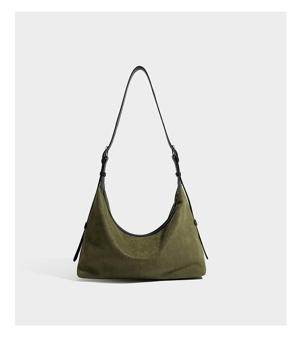 Slouchy olive green canvas hobo shoulder bag with black leather-look trim, zip-top closure, and adjustable strap, detail view