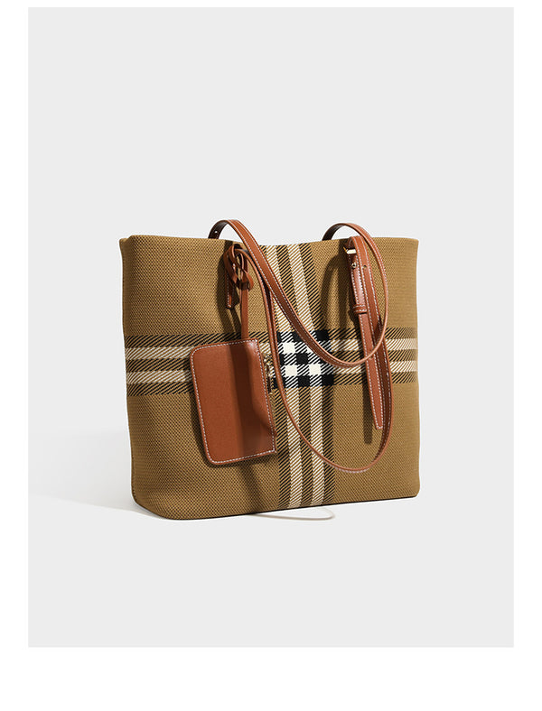 Large structured plaid check tote bag with smooth tan leather-look shoulder straps, attached front zip pouch, and gold-tone
