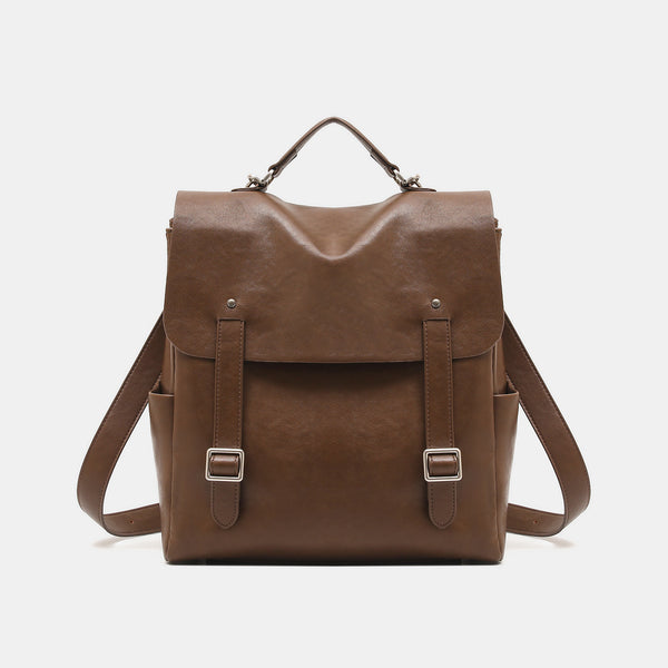 Structured flap backpack handbag in smooth leather-look finish with buckle front pocket, top handle, and silver-tone
