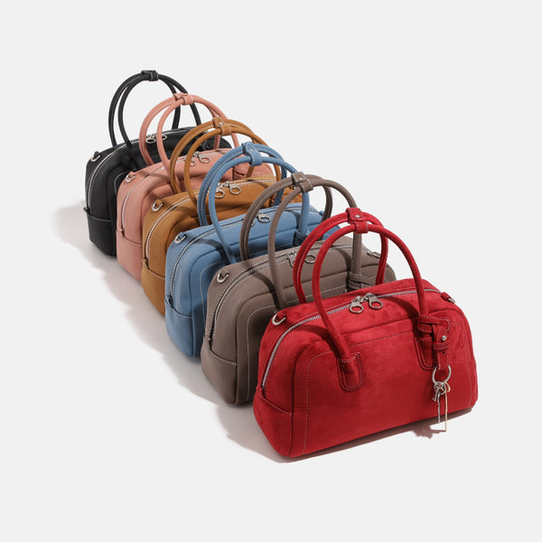 Compact retro Boston satchel bag with matte suede-look finish, twin rounded top handles, double zip closure with silver-tone