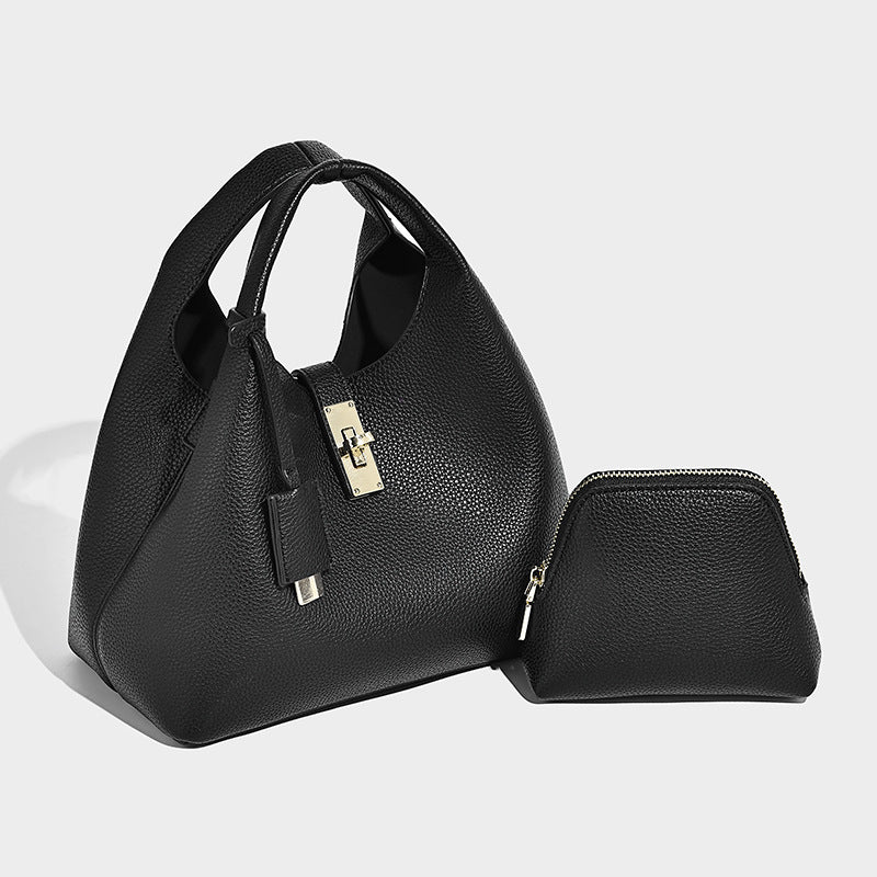Structured pebbled-texture bucket bag with arched top handles, gold-tone turn-lock closure, and detachable shoulder strap