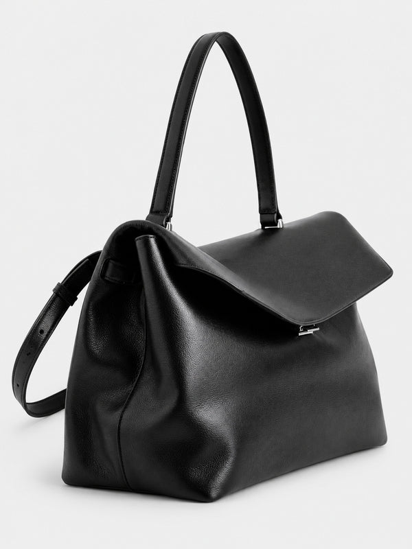 Large black slouchy leather-look shoulder bag with V-shaped envelope flap, silver-tone clasp, and adjustable strap, detail