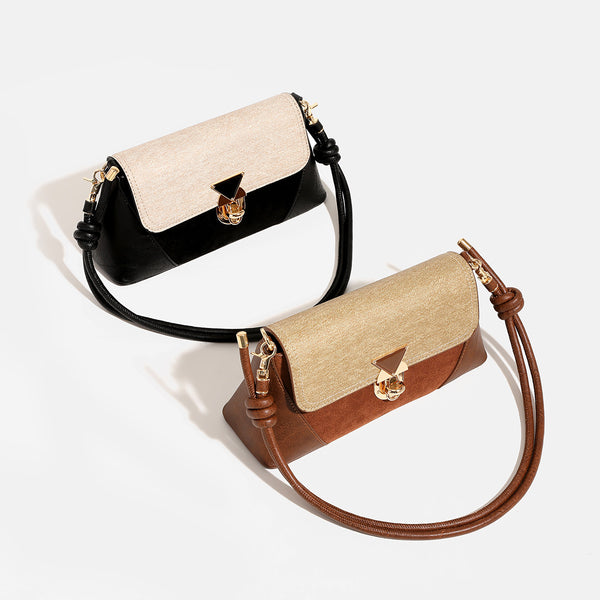 Structured trapezoid shoulder bag with pale textured flap, gold-tone triangular turn-lock closure, and long knotted cord