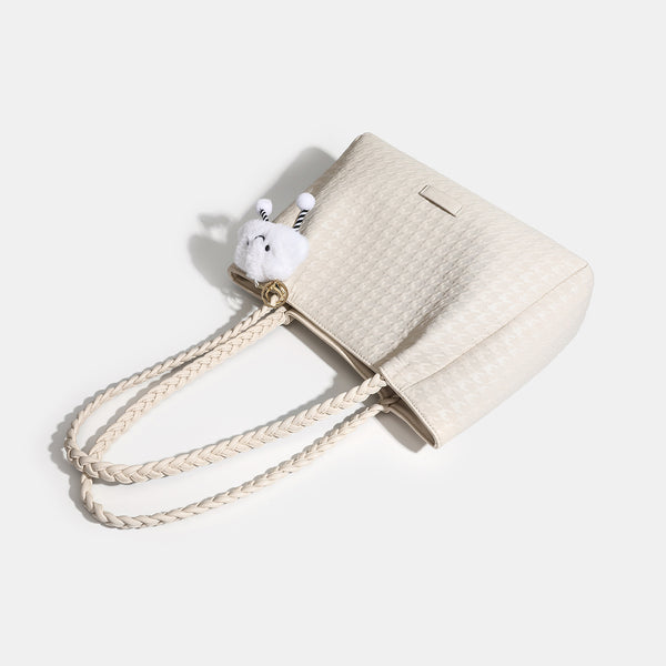 Structured geometric-embossed tote bag with braided shoulder straps and gold-tone hardware in ivory, detail view 3