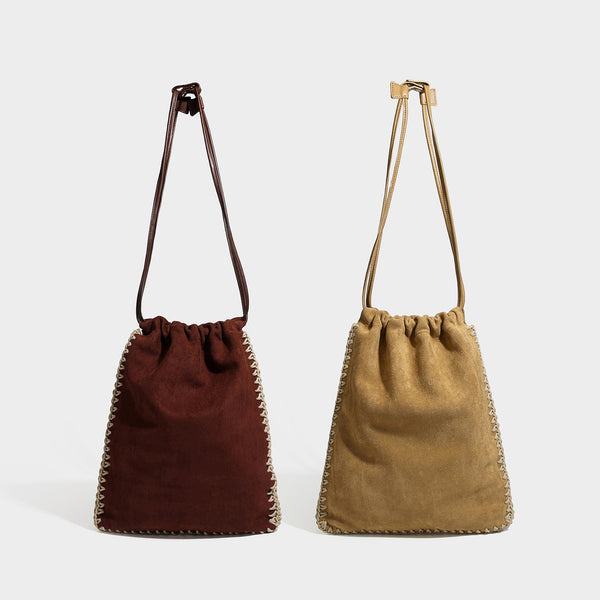 Matte suede-look drawstring bucket bag with cream braided woven edge trim and slim adjustable leather-look shoulder strap