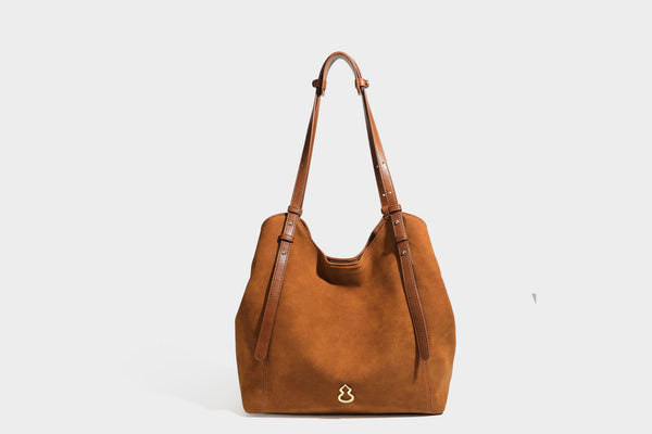 Oversized suede-finish tote shoulder bag in caramel brown with slim leather-look straps and gold-tone logo hardware, detail