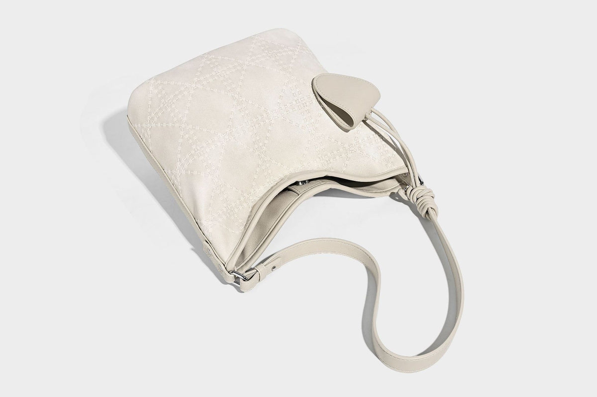 Diamond-quilted leather-look bucket shoulder bag with knotted strap accent and attached mini pouch, detail view 26