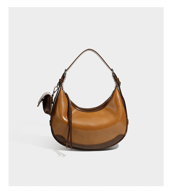 Glossy leather-look crescent hobo shoulder bag with dark contrast trim, silver-tone hardware, and attached mini flap pouch