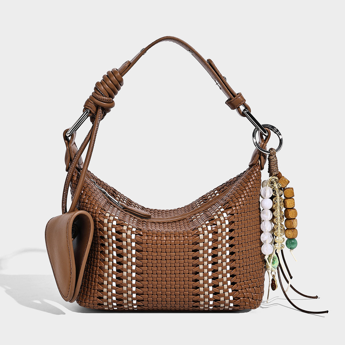 Small woven crescent shoulder bag with leather-look trim, zip closure, silver-tone ring hardware, and beaded tassel charm