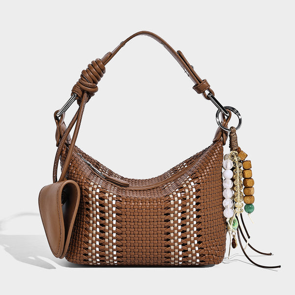 Small woven crescent shoulder bag with leather-look trim, zip closure, silver-tone ring hardware, and beaded tassel charm