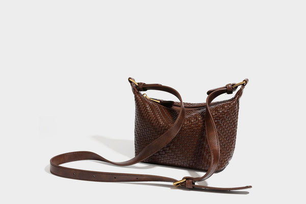 Small glossy basket-weave hobo shoulder bag in brown with knotted top handle, flap accent pocket, and gold-tone hardware