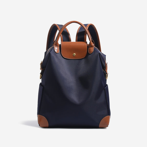 Large matte nylon backpack handbag with cognac leather-look trim, snap flap, and gold-tone hardware, detail view 6
