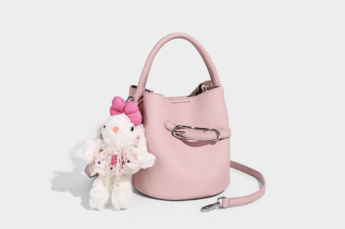 Mini pebbled leather-look bucket bag with front buckle strap, silver-tone hardware, top handle, and detachable shoulder