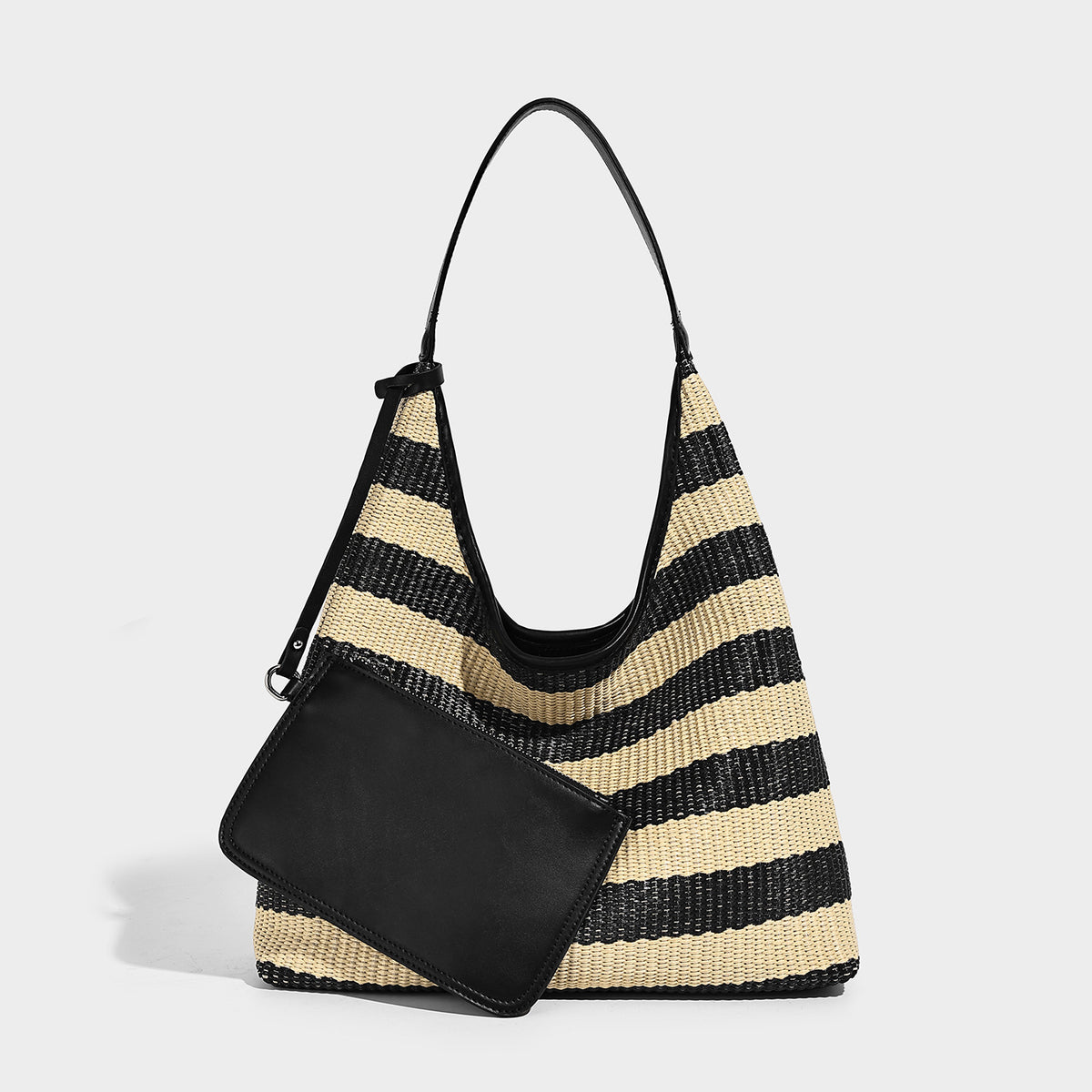 Black and beige striped woven shoulder tote bag with leather-look trim and detachable black zip pouch, detail view 3