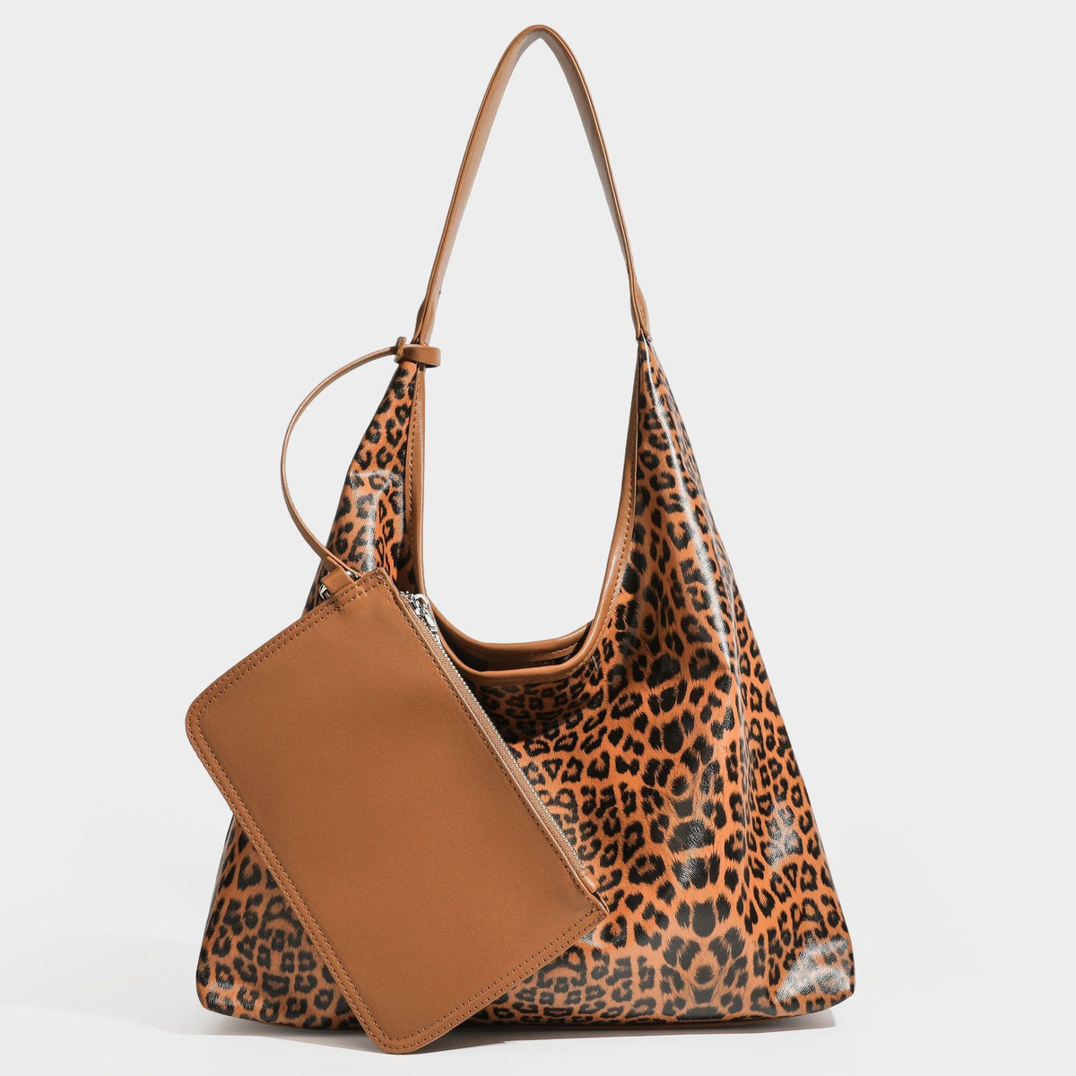 Glossy leopard-print slouchy shoulder bag with long strap and detachable tan zip pouch, detail view 19
