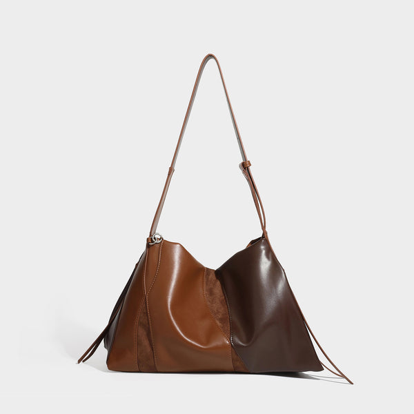 Two-tone black and brown leather-look slouchy shoulder bag with beaded tassel charm and silver-tone hardware, detail view 4