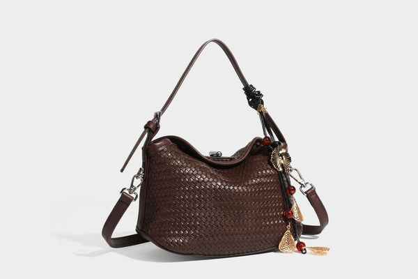 Small woven-look leather-look flap shoulder hobo bag in burgundy with silver-tone hardware and decorative tassel charm
